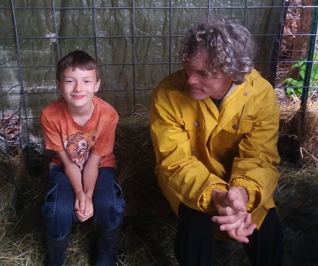Father and son waiting for goat birth